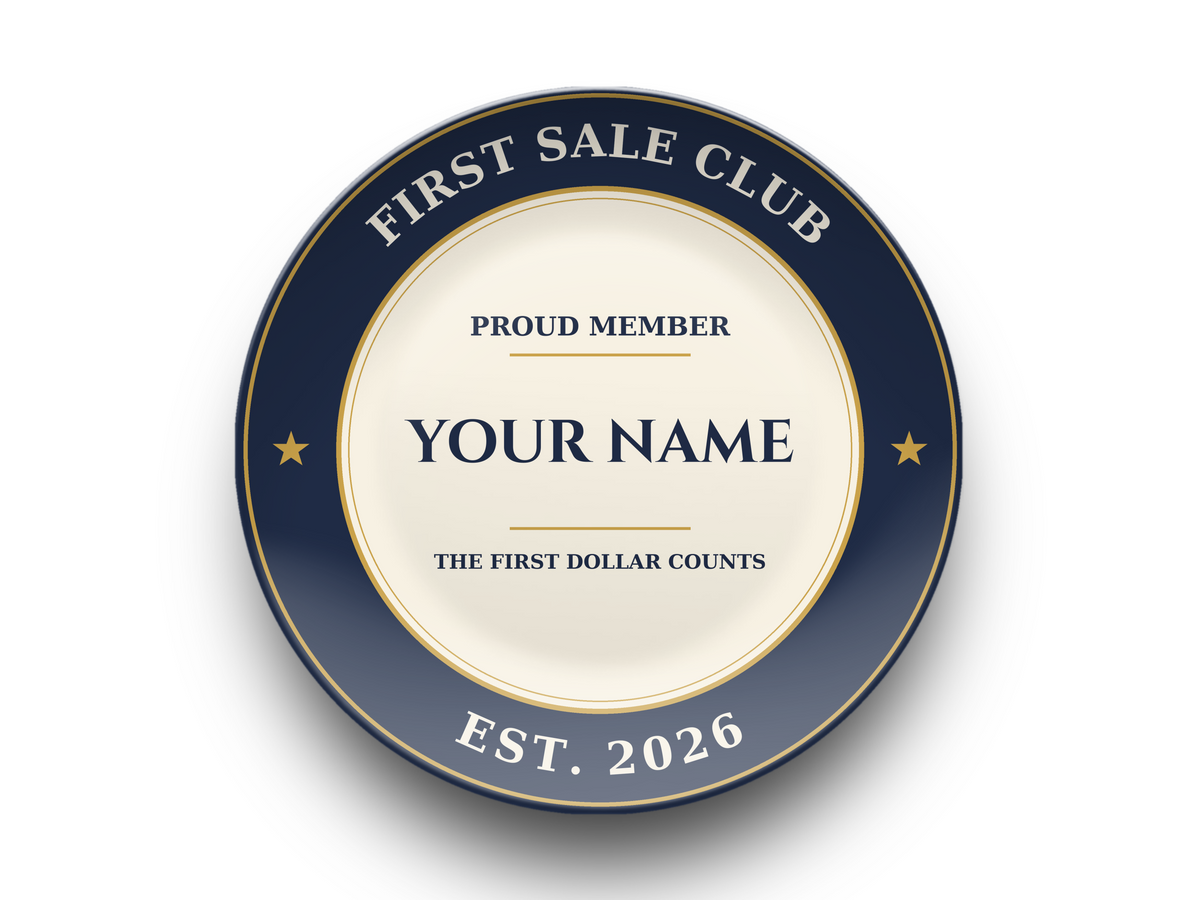 Front view of the First Sale Club personalized plate on white: navy rim, cream center, name printed under Proud Member