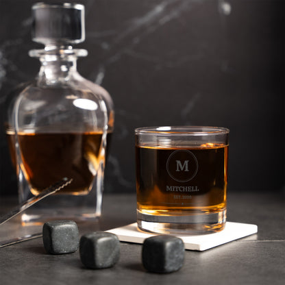 Personalized rocks glass with whiskey stones and a crystal decanter