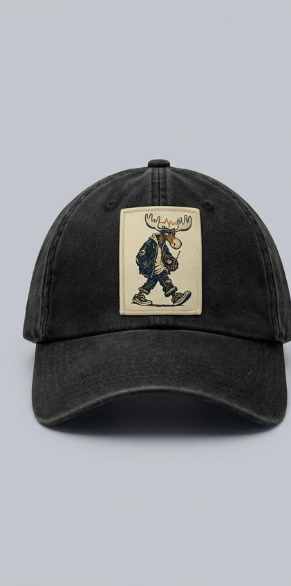 Washed-black curved-brim cap, front view, with a rectangular cream patch showing Night Shift Chester walking in sneakers and carrying an analog radio; design mockup.