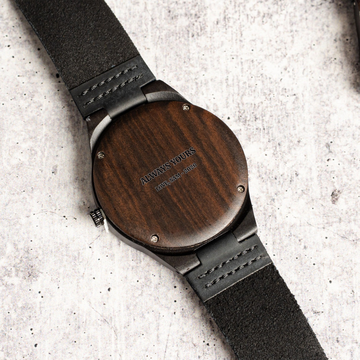 Close-up of the laser-engraved message on the back of the wood watch case