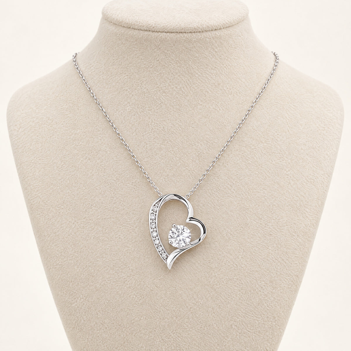 Forever Love heart necklace with cubic zirconia center stone on a display bust