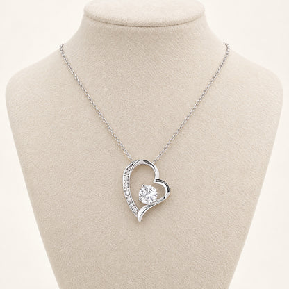 Forever Love heart necklace with cubic zirconia center stone on a display bust