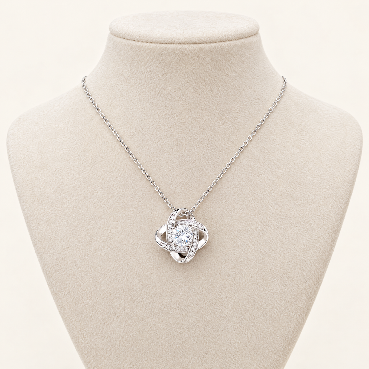 Love Knot necklace displayed on a cream jewelry bust