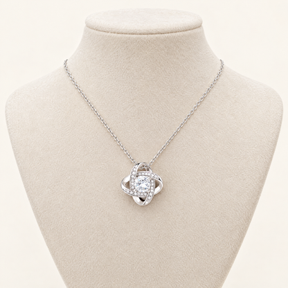 Love Knot necklace displayed on a cream jewelry bust