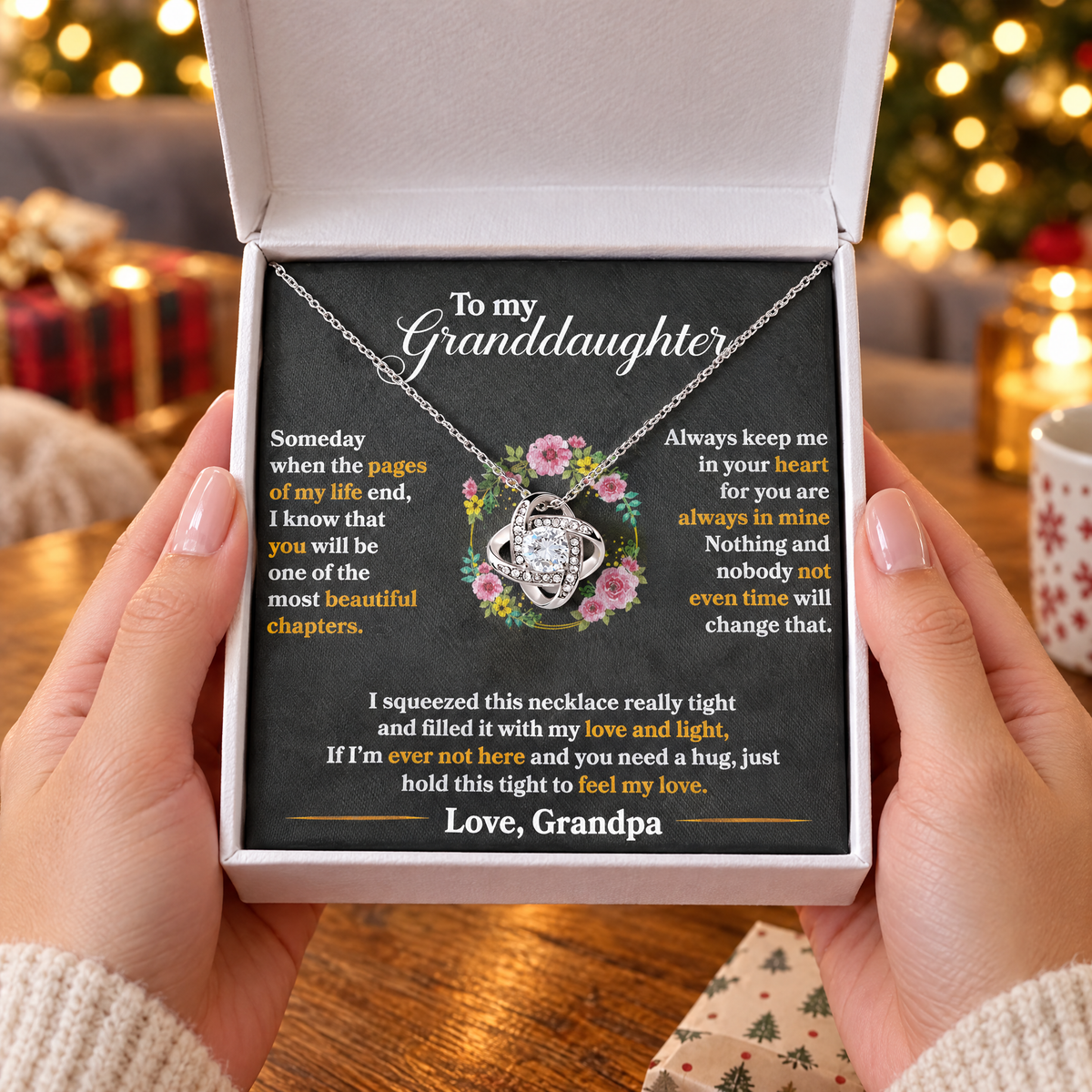 Gift box with the Love Knot necklace and its printed message card, held in two hands