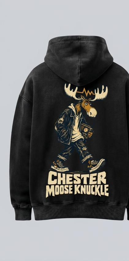 Washed-black oversized hoodie, back view, with cream-and-brass Night Shift Chester in a jacket and sneakers carrying an analog radio above the brand name; design mockup.